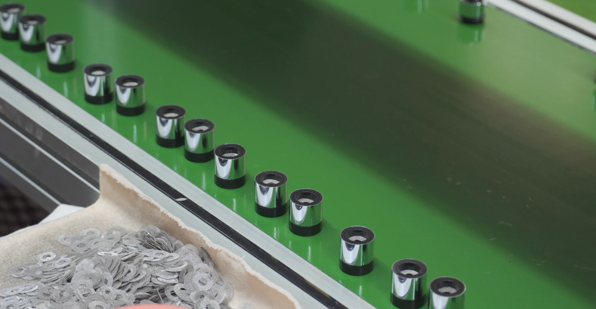 Finished faucet aerators on the production conveyor